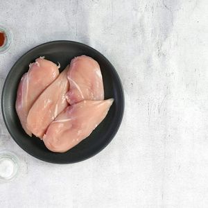 Peitos de frango crus em uma tigela